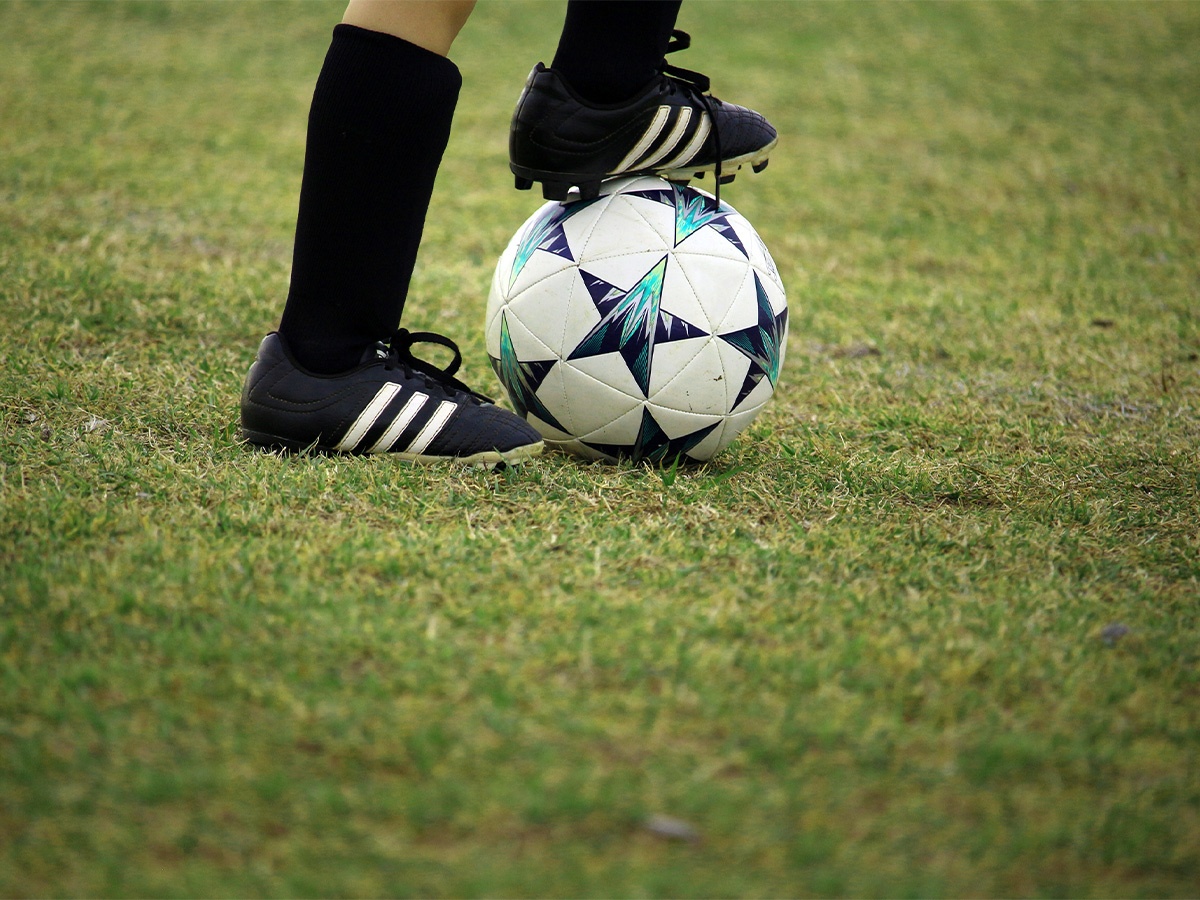 Close up of shoes and soccer ball
